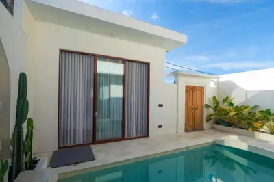 a villa with a swimming pool and a house at NEW! Villa Imaera - 2BR Villa in Kerobokan in Kerobokan