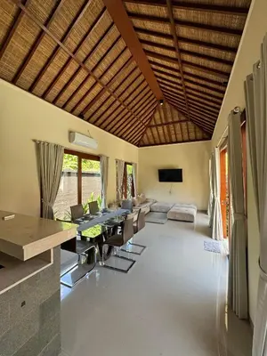 a living room with a table and a couch at Ocean Cantik Villa in Canggu
