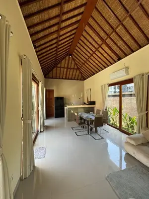 a large living room with a table and chairs at Ocean Cantik Villa in Canggu