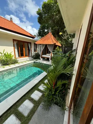 a swimming pool in the backyard of a house at Ocean Cantik Villa in Canggu