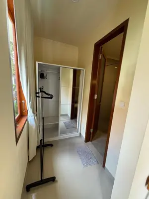 a bathroom with a walk in shower next to a glass door at Ocean Cantik Villa in Canggu