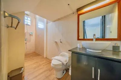 a bathroom with a sink and a toilet and a mirror at Villa Cahaya Berlian in Kerobokan