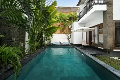 a swimming pool in the backyard of a house at Villa Zambrud Sanur Elegant Tropical Villa with Private Pool & Garden and Garage in Sanur