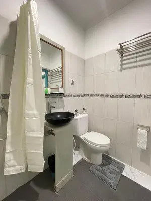 a bathroom with a toilet and a sink and a mirror at Beachview Residence in Seminyak