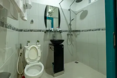 a bathroom with a toilet and a sink at Beachview Residence in Seminyak
