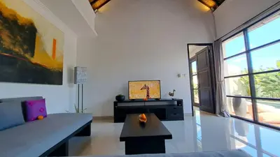a living room with a couch and a table at Villa Sofia in Seminyak