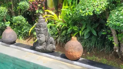 three vases sitting on a ledge in a garden at Seminyak Tropical Oasis Center-3 Br-Private Pool in Seminyak