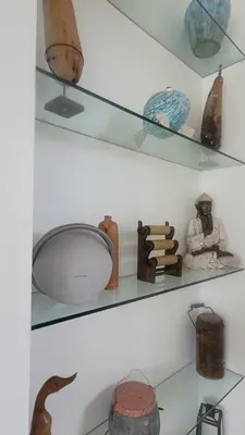 a shelf filled with different types of pottery at Seminyak Tropical Oasis Center-3 Br-Private Pool in Seminyak