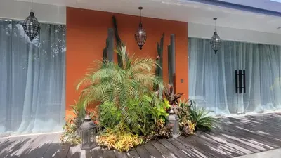 a room with some plants on a wooden floor at Seminyak Tropical Oasis Center-3 Br-Private Pool in Seminyak