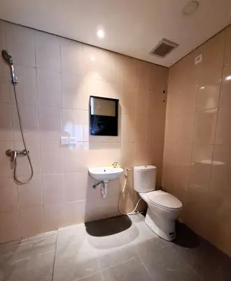 a bathroom with a toilet and a sink at Wisman House by Pigeon in Jimbaran