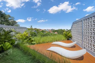 a view of two white chairs on a balcony at New 2BR Architectural Masterpiece in Umalas in Kerobokan