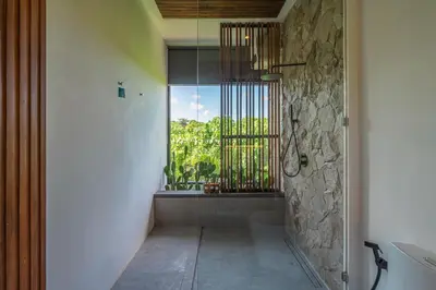 a bathroom with a window and a walk in shower at Bedawang, Exquisite Seminyak 4BR Villa with Huge Pool in Seminyak