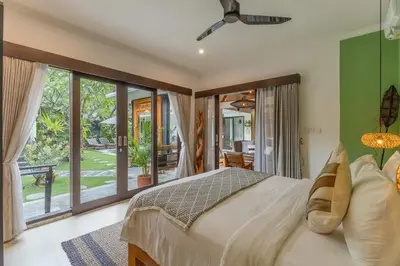 a bedroom with a bed and a large window at Villa Mint Dua, Peaceful 3BR Villa - Near La favela Seminyak in Seminyak