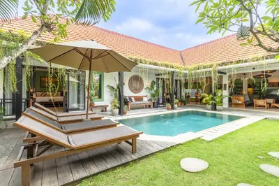 a villa with a swimming pool and a patio at Villa Mint Dua, Peaceful 3BR Villa - Near La favela Seminyak in Seminyak