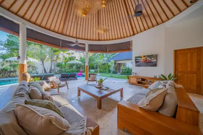 a living room with a couch and a table at 7 BR Luxury Oasis in Seminyak in Seminyak