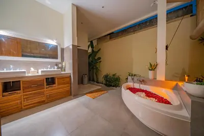 a bathroom with a large tub and two sinks at 7 BR Luxury Oasis in Seminyak in Seminyak