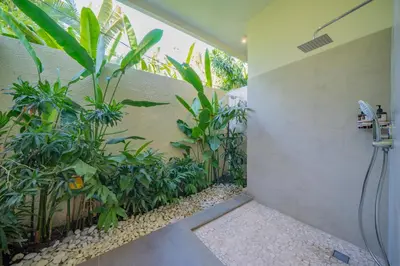 a bathroom with a shower with plants in it at 7 BR Luxury Oasis in Seminyak in Seminyak