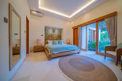 a bedroom with a bed and a large window at 7 BR Luxury Oasis in Seminyak in Seminyak