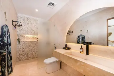 a bathroom with a sink and a toilet and a shower at Villa Mawali in Legian