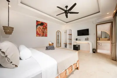 a bedroom with a bed and a ceiling fan at Villa Mawali in Legian
