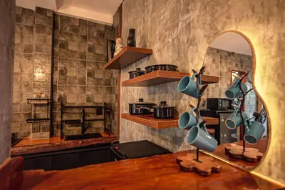 a kitchen with a table and a mirror on the wall at Amshiga 4 in Jimbaran