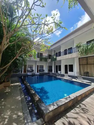 a swimming pool in front of a building at Saphala Suites Secondfloor in Seminyak