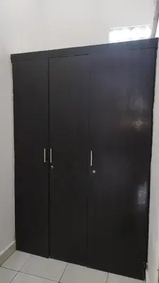 a pair of black cabinets in a room at Saphala Suites Secondfloor in Seminyak