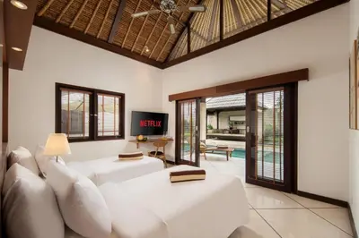 a living room with a white couch and windows at HUGE 9 BR, 10 BATHR Villa, Best Location near beach in Canggu