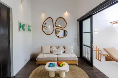 a living room with a couch and a table at Villa Gael by Pertama Management in Seminyak