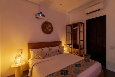 a bedroom with a bed with a clock on the wall at Villa Gael by Pertama Management in Seminyak