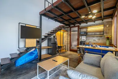 a living room with a couch and a big screen tv at First 5 Loft near Seminyak in Seminyak