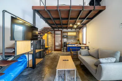 a living room with a couch and a table at First 5 Loft near Seminyak in Seminyak