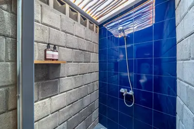 a bathroom with a blue tiled shower at First 5 Loft near Seminyak in Seminyak