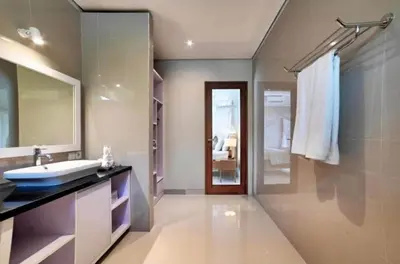 a bathroom with a sink and a mirror at Villa LAKSMI in Seminyak