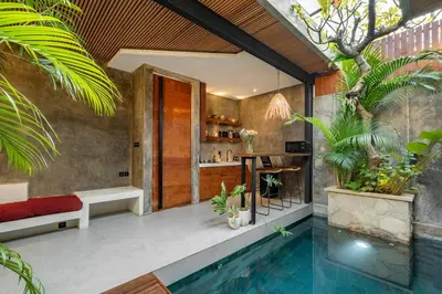 a bathroom with a swimming pool next to a house at Romantic Honeymoon Villa - Private Pool & Netflix in Dalung