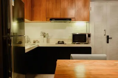 a kitchen with a black refrigerator and a microwave at UrbanVilla in Legian