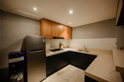 a kitchen with a refrigerator and a sink at Urban Villas 5BR in Legian