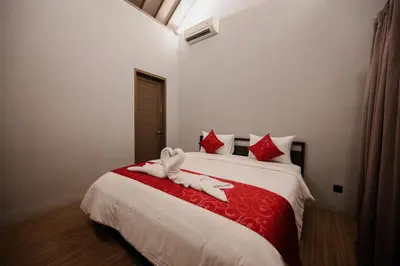 a bedroom with a bed with a stuffed animal on it at Urban Villas 5BR in Legian