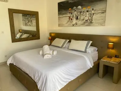 a bedroom with a large bed with towels on it at Luxury 3 BR Elegant intertior Perfect for group in Kerobokan