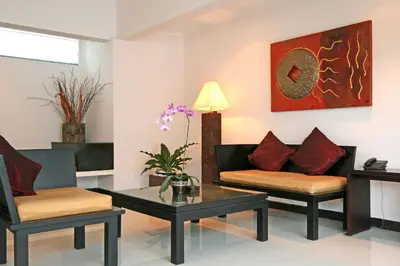 a living room with two chairs and a coffee table at Rishi Villas in Kerobokan