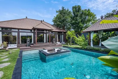 a swimming pool in the backyard of a house at Exclusive 4BR Villa Kito - Cinema, Sauna, Yoga and Pool in Jimbaran