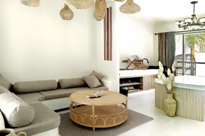 a living room with a couch and a table at Sandwood Bejiayu in Seminyak
