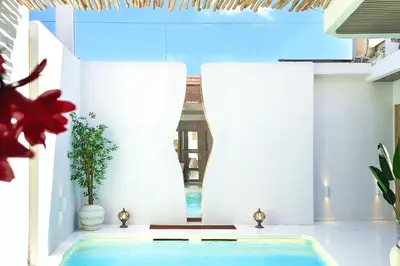 a house with a swimming pool in a room at Sandwood Bejiayu in Seminyak