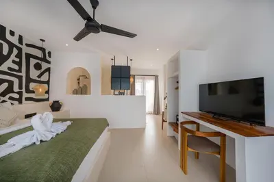 a bedroom with a bed and a flat screen tv at Villa Aura - Spacious 1BR Private Pool Luxury Villa in Seminyak