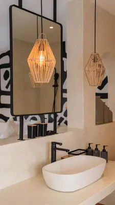 a bathroom sink with two lights and a mirror at Villa Aura - Spacious 1BR Private Pool Luxury Villa in Seminyak