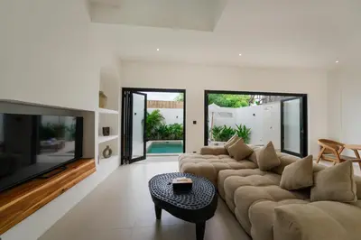 a living room with a couch and a table at Villa Aura - Spacious 1BR Private Pool Luxury Villa in Seminyak