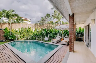 a swimming pool in the backyard of a house at Stylish 3BR Villa in Central Berawa Canggu - near Finns in Canggu