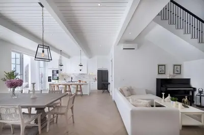 a white living room with a table and a couch at Colonial House 4BR Villa Ocean View in Berawa in Canggu