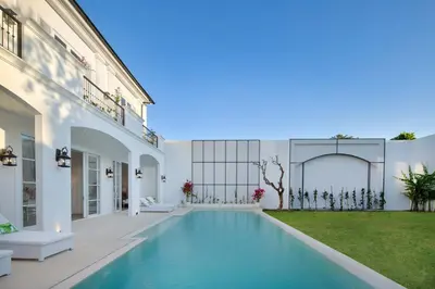 a swimming pool in the backyard of a house at Colonial House 4BR Villa Ocean View in Berawa in Canggu