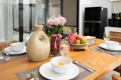 a table with a vase and a bowl of fruit at Villa Bella Poppy in Seminyak